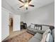 Living room featuring a sectional sofa, rug, fan and an adjacent room with a desk at 1528 Highland Park Dr, Clearwater, FL 33756