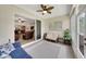 Sun room with tile flooring, fan, and a view into the living room at 1528 Highland Park Dr, Clearwater, FL 33756
