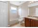 A well-lit bathroom with a tub/shower combo, tile floor, and vanity with a sink at 18320 Snowdonia Dr, Land O Lakes, FL 34638
