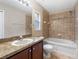 Bright bathroom features a soaking tub with tiled walls and vanity at 18320 Snowdonia Dr, Land O Lakes, FL 34638