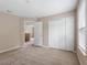 Bright bedroom featuring neutral paint, carpet floors, a closet and an open door leading to another room at 18320 Snowdonia Dr, Land O Lakes, FL 34638