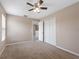 A bedroom featuring a ceiling fan, closet, carpet, and natural lighting from a window at 18320 Snowdonia Dr, Land O Lakes, FL 34638