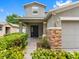 Close-up of the home's front entrance showing stacked stone details and verdant landscaping at 18320 Snowdonia Dr, Land O Lakes, FL 34638