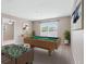 Game room featuring a foosball table, a pool table with decorations, and window lighting at 18320 Snowdonia Dr, Land O Lakes, FL 34638