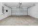 A garage with concrete floors, a garage door, and an electrical panel at 18320 Snowdonia Dr, Land O Lakes, FL 34638