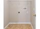 An empty laundry room includes tile flooring, connections, and a wire shelf for storage at 18320 Snowdonia Dr, Land O Lakes, FL 34638