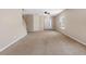 Large, carpeted living room with plenty of natural light at 18320 Snowdonia Dr, Land O Lakes, FL 34638