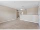 Spacious loft area with neutral walls and carpet, offering versatile living space and natural lighting at 18320 Snowdonia Dr, Land O Lakes, FL 34638