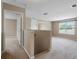 A neutral-toned loft with carpeting, view of bedrooms, and natural light from a window at 18320 Snowdonia Dr, Land O Lakes, FL 34638