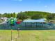 Wide shot of a colorful and expansive playground featuring slides, climbing structures, and covered seating at 18320 Snowdonia Dr, Land O Lakes, FL 34638