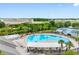 Aerial view of the community pool, splash pad, and tennis courts with beautiful landscaping at 18320 Snowdonia Dr, Land O Lakes, FL 34638