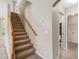 Carpeted staircase with a wooden railing at 18320 Snowdonia Dr, Land O Lakes, FL 34638