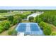 Aerial view of community tennis courts, surrounded by mature trees and greenery at 18320 Snowdonia Dr, Land O Lakes, FL 34638