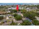 Aerial view of the home with a manicured lawn, mature trees and landscaping, conveniently located near the bay at 2048 Douglas Ave, Dunedin, FL 34698
