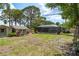A Large backyard with cottages, pool enclosure and green lawn at 2048 Douglas Ave, Dunedin, FL 34698