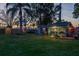 Backyard cottages with large yard and decorative lighting in the evening at 2048 Douglas Ave, Dunedin, FL 34698