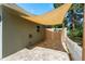 A Cozy backyard patio with pavers, sunshade, white fence and a Welcome sign on a gated entrance at 2048 Douglas Ave, Dunedin, FL 34698