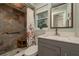 Updated bathroom showcasing a stone-tile walk-in shower with a decorative glass ceiling at 2048 Douglas Ave, Dunedin, FL 34698