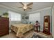 Bedroom featuring neutral paint, bright natural light, and a ceiling fan at 2048 Douglas Ave, Dunedin, FL 34698