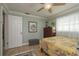 Cozy bedroom features a yellow floral comforter, chest of drawers, and a bright window at 2048 Douglas Ave, Dunedin, FL 34698
