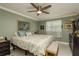 Cozy bedroom with a ceiling fan, neutral paint, and bright natural light at 2048 Douglas Ave, Dunedin, FL 34698