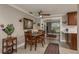Cozy dining room featuring tile floors, modern lighting, and a warm neutral palette adjacent to the living room at 2048 Douglas Ave, Dunedin, FL 34698