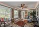 Bright Florida room with slate floors, lots of windows, and a ceiling fan at 2048 Douglas Ave, Dunedin, FL 34698