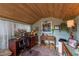 Home office space with wood paneled ceiling, decorative stained glass window and modern desk at 2048 Douglas Ave, Dunedin, FL 34698