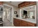 Eat-in kitchen showcases a view into the living room with bright countertops and wood cabinetry at 2048 Douglas Ave, Dunedin, FL 34698