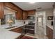 Updated kitchen featuring stainless steel appliances, rich wood cabinets, and white countertops at 2048 Douglas Ave, Dunedin, FL 34698