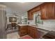 Charming kitchen featuring updated appliances, a stylish backsplash, and wood cabinetry at 2048 Douglas Ave, Dunedin, FL 34698