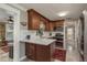 Modern kitchen with updated appliances, white countertops, and dark wood cabinetry conveniently open to the dining room at 2048 Douglas Ave, Dunedin, FL 34698