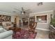 A spacious living room featuring tiled flooring, neutral paint, and a seamless transition to the dining and kitchen area at 2048 Douglas Ave, Dunedin, FL 34698