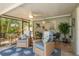 Relaxing screened-in patio with comfortable seating and lush outdoor views at 2048 Douglas Ave, Dunedin, FL 34698