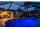 Inviting in-ground pool with underwater lights and a large, screened enclosure at 2048 Douglas Ave, Dunedin, FL 34698