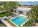 Aerial view showcasing the pool, outdoor dining, lush backyard, and waterfront access of the property at 2084 Massachusetts Ne Ave, St Petersburg, FL 33703