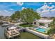 Aerial view of waterfront property featuring a pool, dock, and lush landscaping at 2084 Massachusetts Ne Ave, St Petersburg, FL 33703