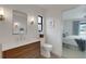 Bathroom featuring a vanity, toilet, and a view of a bedroom with access to the waterway at 2084 Massachusetts Ne Ave, St Petersburg, FL 33703