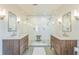 Elegant bathroom featuring a double vanity, a large glass shower and modern fixtures at 2084 Massachusetts Ne Ave, St Petersburg, FL 33703