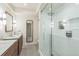 Bright bathroom featuring a glass-enclosed shower with white subway tile and hexagon tile floor at 2084 Massachusetts Ne Ave, St Petersburg, FL 33703