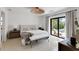 Bright bedroom with a decorative ceiling light, sliding doors to the pool and deck at 2084 Massachusetts Ne Ave, St Petersburg, FL 33703