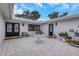 Charming courtyard featuring tile floors, lovely potted plants, and a white table at 2084 Massachusetts Ne Ave, St Petersburg, FL 33703