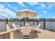 Dock sitting area with an umbrella and chairs overlooking the water and neighborhood homes on a sunny day at 2084 Massachusetts Ne Ave, St Petersburg, FL 33703