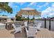 Dock seating area overlooking the pool and backyard of the home and waterfront neighborhood on a sunny day at 2084 Massachusetts Ne Ave, St Petersburg, FL 33703