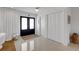 Bright entryway featuring black double doors and polished terrazzo flooring at 2084 Massachusetts Ne Ave, St Petersburg, FL 33703