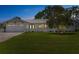 Charming single-story home with a well-manicured lawn, attached garage, and freshly painted white exterior at 2084 Massachusetts Ne Ave, St Petersburg, FL 33703