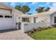 Beautiful home with a well-manicured lawn and an address plaque at the entrance at 2084 Massachusetts Ne Ave, St Petersburg, FL 33703