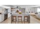 Modern kitchen with stainless steel appliances, island seating, and open layout at 2084 Massachusetts Ne Ave, St Petersburg, FL 33703