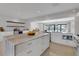 Bright kitchen features marble counters, modern appliances, and an island with storage at 2084 Massachusetts Ne Ave, St Petersburg, FL 33703