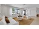 Bright and open living room with neutral tones, modern furniture, and large windows at 2084 Massachusetts Ne Ave, St Petersburg, FL 33703